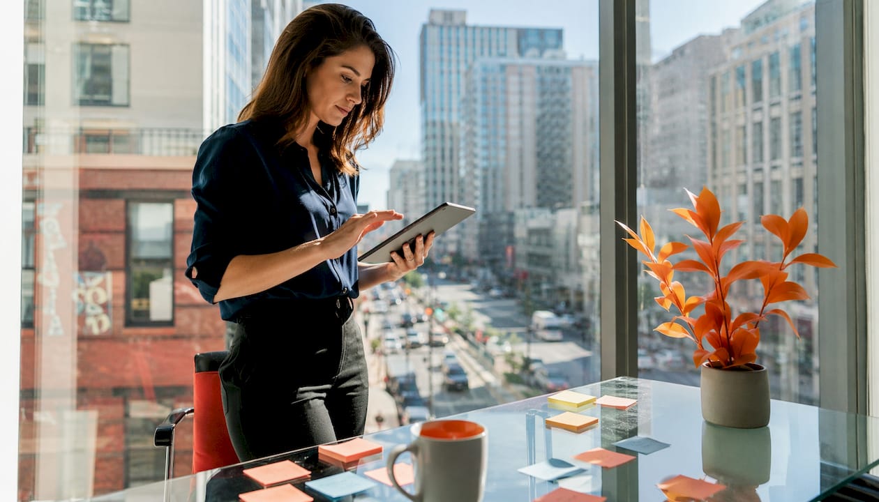 Event marketer planning route on tablet and map