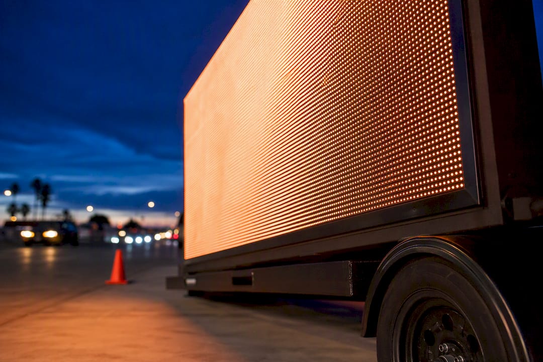 Cropped LED billboard rig at dusk