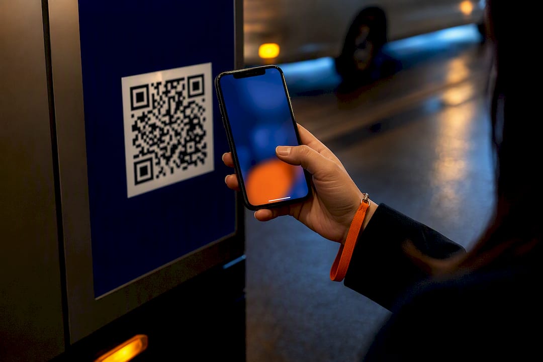 Marketer scanning QR code on billboard panel