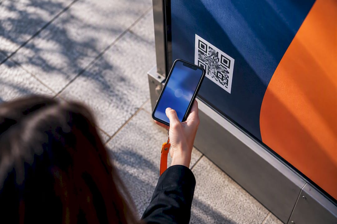 Marketer scanning QR code on ad panel