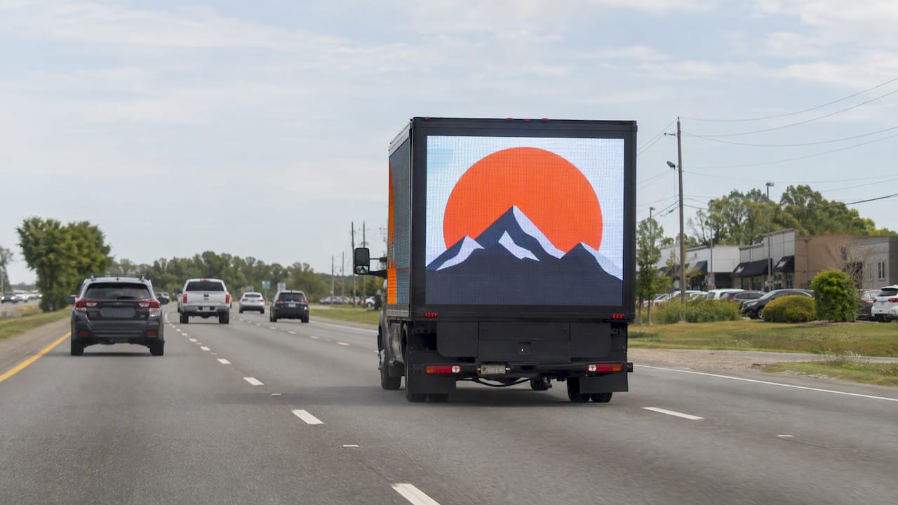 Mobile billboard viewed from far down a bypass